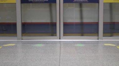 foot view to platform of subway metro train station train commuter opens the door full of passenger inside