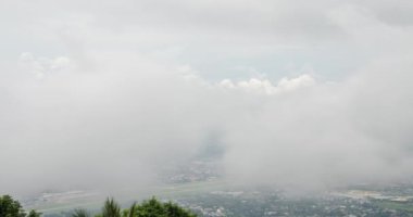 timelapse view of the chiang mai airport from Doi Suthep mountain above the cloud level in winter time