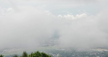 timelapse view of the chiang mai airport from Doi Suthep mountain above the cloud level in winter time