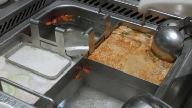 put raw shrimp ball into hot boil spicy soup.szechuan chinese hotpot syle
