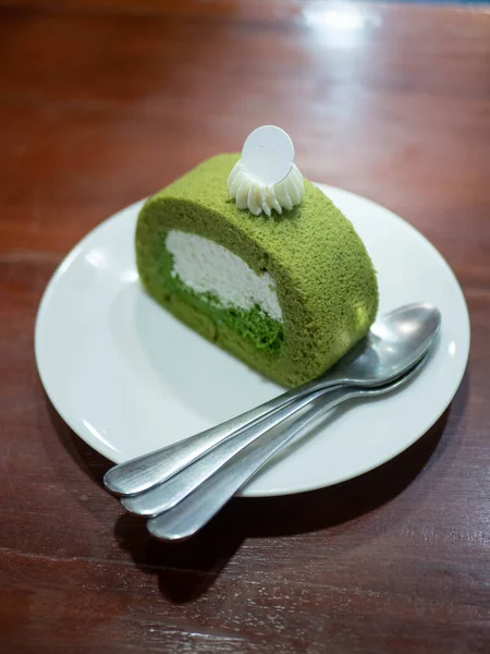 matcha green tea fresh cream roll cake in while plate