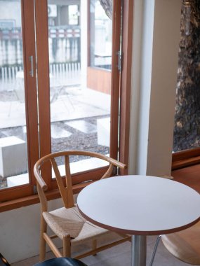 view of empty table with chair inside minimal japanese style cafe near window