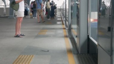 June 3,2022:Bangkok,Thailand:view to platform of sky train station while passenger waiting and get into the train