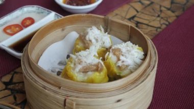 Lokantada Çin Dim Sum buğulaması yemek için çubuk kullanmak. Çin lokantasında ünlü suimai.