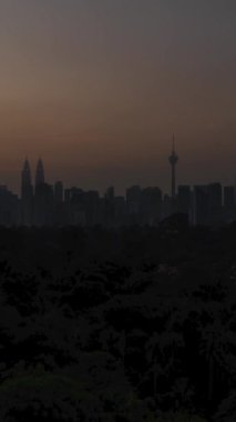 Kuala lumpur şehir merkezi şehir merkezinin dikey zaman çizelgesi. Birçok gökdelen binası var. Günbatımında güzel bir günbatımında günbatımı gökyüzü ve KL manzarası olan modern tarz kuleler.