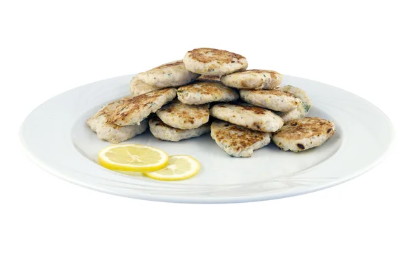 Pile of chicken cutlets on a plate with lemon — Stock Photo, Image