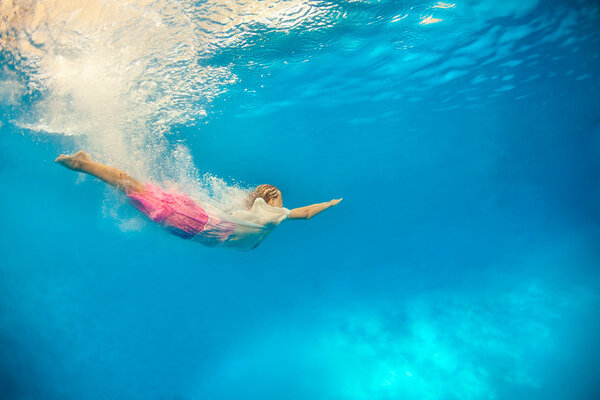 Girl dives in water