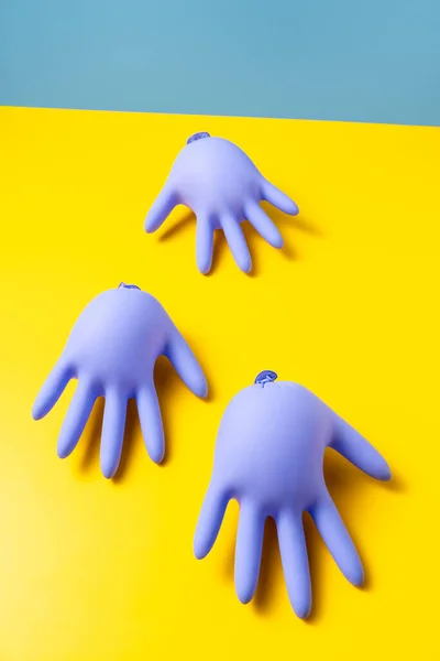 Few Purple Inflated Latex Gloves Vibrant Yellow Surface Bright Blue —  Fotos de Stock