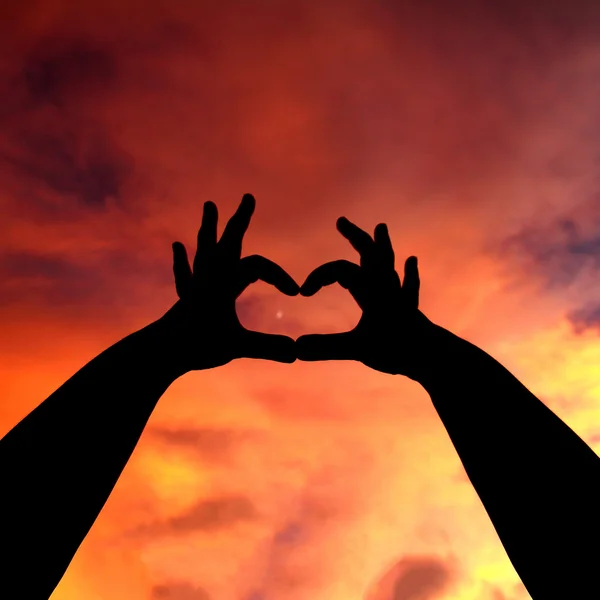 Miłość ręka sylwetka w niebo — Zdjęcie stockowe