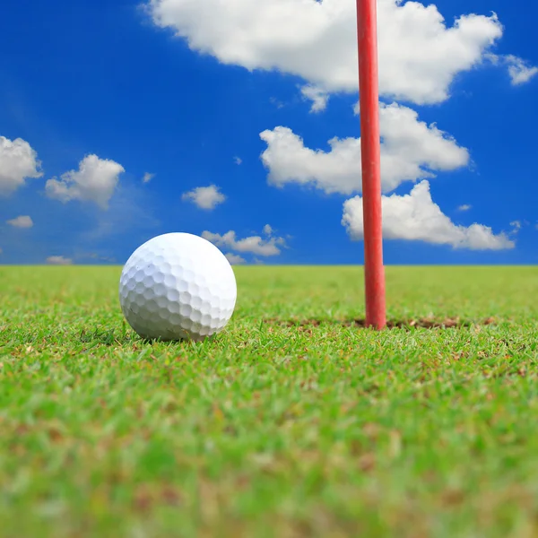 Golf ball on lip of cup — Stok fotoğraf