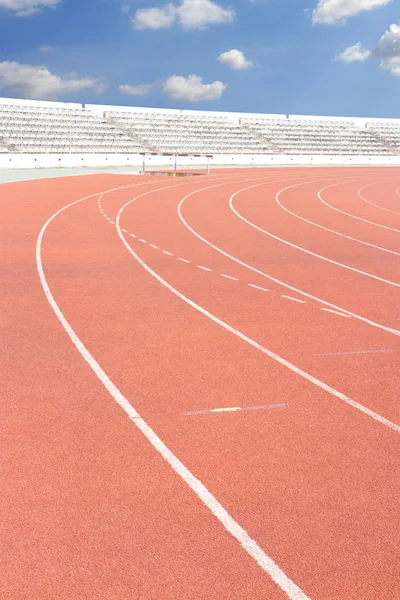 Running track over blue sky and clouds — Stock Photo, Image