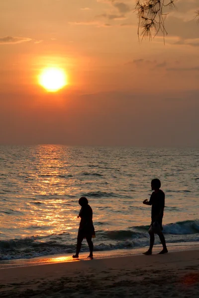 Una coppia che cammina al tramonto sulla spiaggia thailandese — Foto Stock