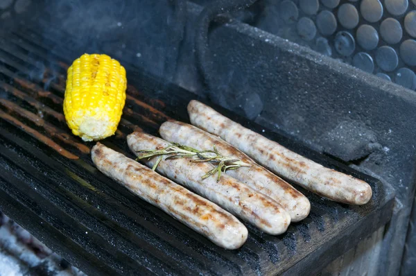 Cooking sausages on the grill — Stock Photo, Image