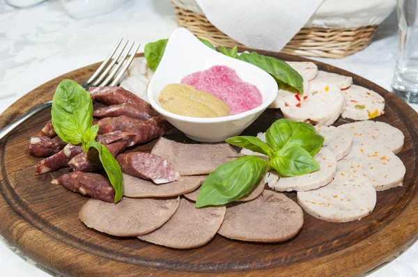 A plate of sausages and bacon sauce — Stock Photo, Image