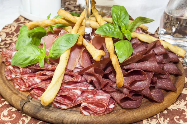 A plate of sausages and bacon sauce — Stock Photo, Image