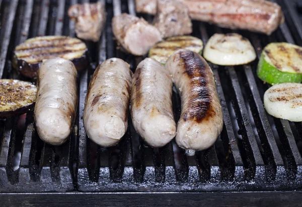 Cooking sausages on the grill — Stock Photo, Image