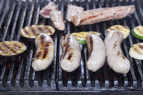 Cooking sausages on the grill — Stock Photo, Image