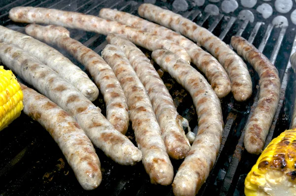 Cooking sausages on the grill — Stock Photo, Image