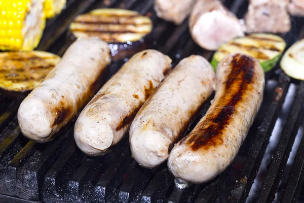 Cooking sausages on the grill — Stock Photo, Image