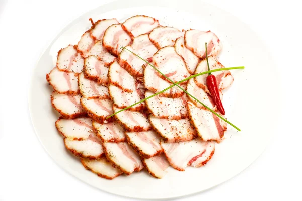 Bacon, onion and pepper on a plate in a restaurant — Stock Photo, Image