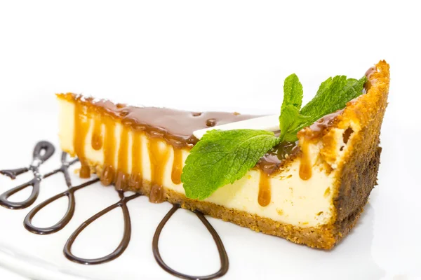 A piece of cheese cake decorated with mint — Stock Photo, Image