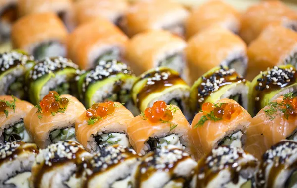 Japanese rolls with fish and vegetables — Stock Photo, Image