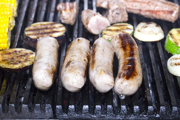 Cooking sausages on the grill — Stock Photo, Image