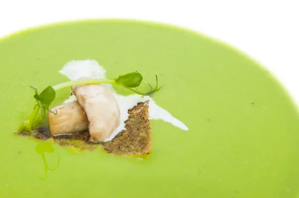 Pea soup on a white dish at restaurant — Stock Photo, Image