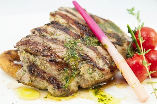 Grilled steak with sauce and greens on white background — Stock Photo, Image