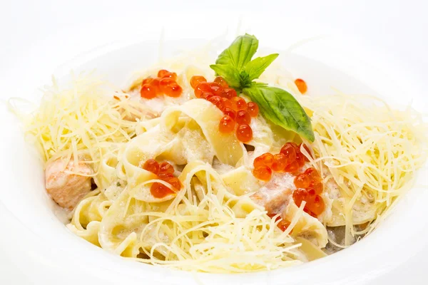 Pasta with fish red caviar and cheese on the table in a restaurant — Stock Photo, Image