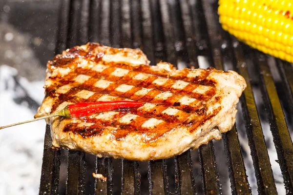 Cooking beef steak on a grill in the restaurant — Stock Photo, Image