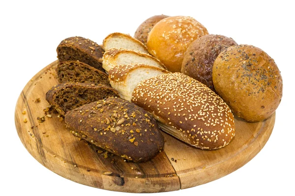 Bread and buns on wooden plate — Stock Photo, Image