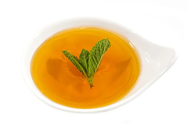Dish decorated with mint and honey — Stock Photo, Image