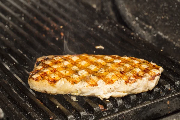 Catfish steak cooking on the grill — Stock Photo, Image