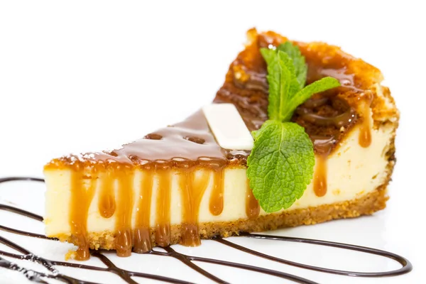 A piece of cheese cake decorated with mint leaves — Stock Photo, Image