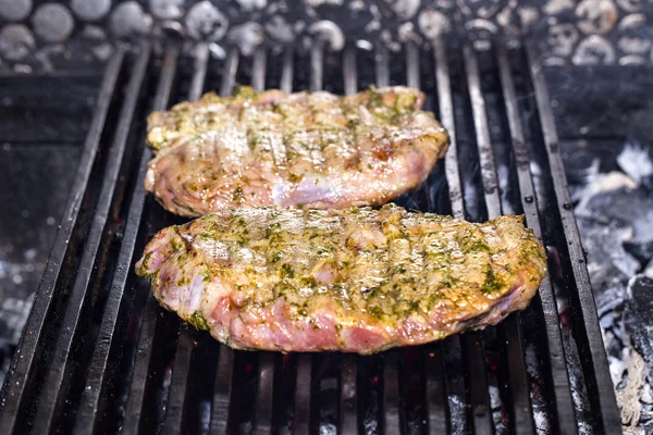 Cooking beef steak on a grill in the restaurant — Stock Photo, Image