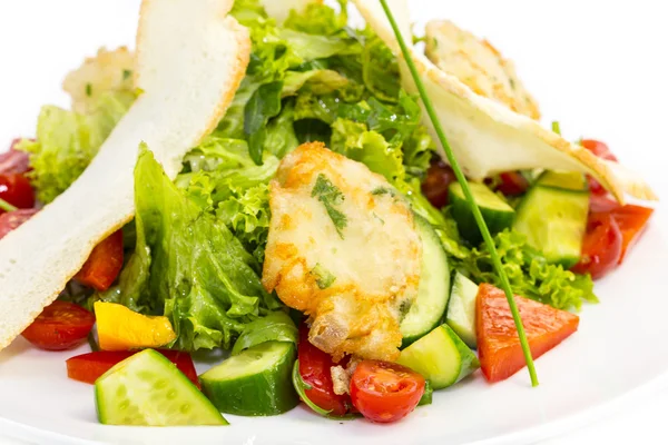 Salad with cheese and vegetables on a table in a restaurant — Stock Photo, Image