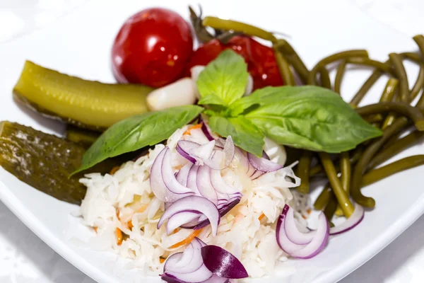 Pickled vegetables, cucumber tomatoes asparagus and garlic cabbage — Stock Photo, Image