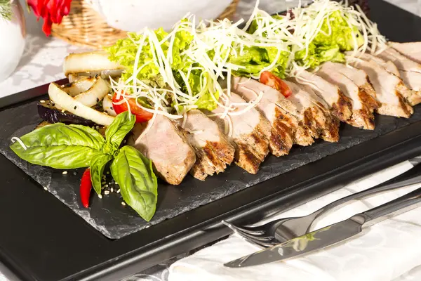 Meat roasted on a grill with vegetables — Stock Photo, Image