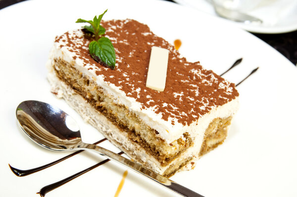 Tiramisu on a white plate in a restaurant