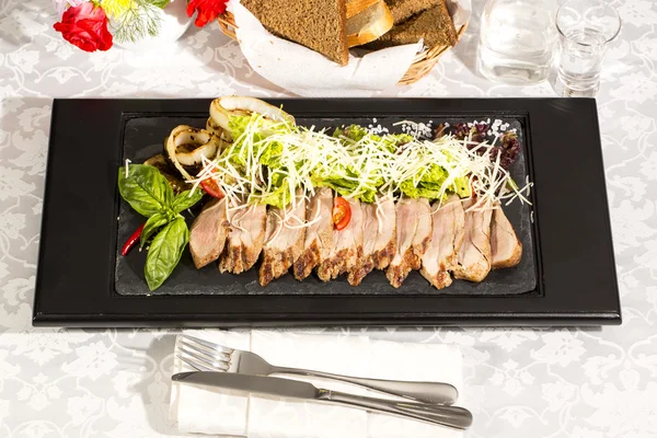 Meat roasted on a grill with vegetables — Stock Photo, Image