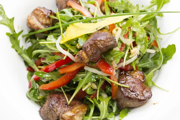 Rabbit liver salad with arugula in a restaurant — Stock Photo, Image