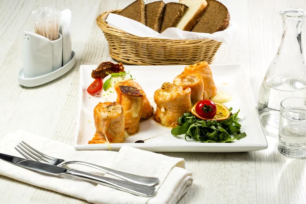 Gebackene Lachsbrötchen auf einem Tisch in einem Restaurant — Stockfoto