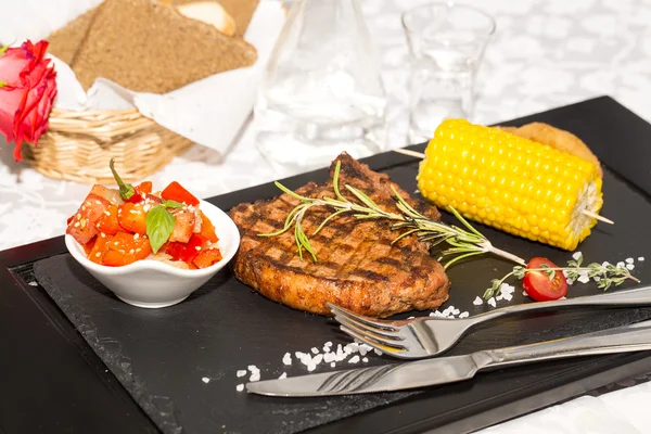 A steak with vegetables served on a hot stone — Stock Photo, Image