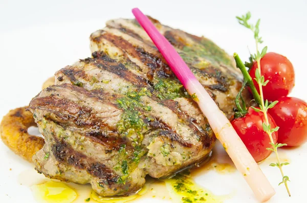 Grilled steak with sauce and greens on white background — Stock Photo, Image