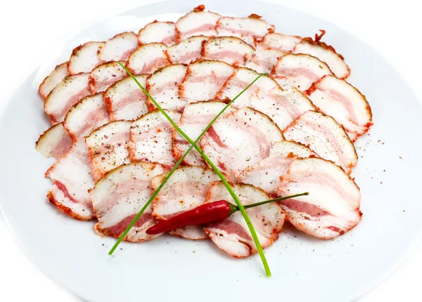 Tocino, cebolla y pimienta en un plato en un restaurante — Foto de Stock