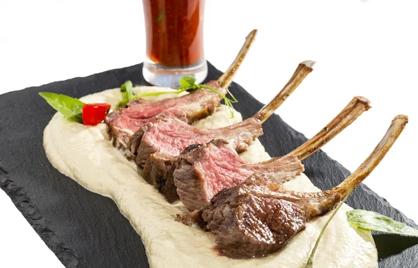 Lamb ribs cooked on the grill served on a hot stone — Stock Photo, Image