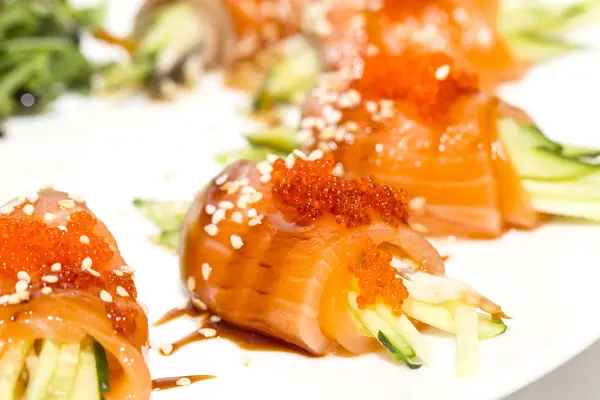 Rolls of salmon with cucumber and caviar — Stock Photo, Image