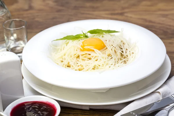 Spaghetti with egg on a table in a restaurant — Stock Photo, Image