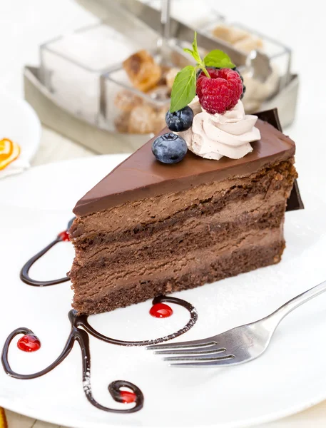 Piece of chocolate cake on a table in a restaurant — Stock Photo, Image